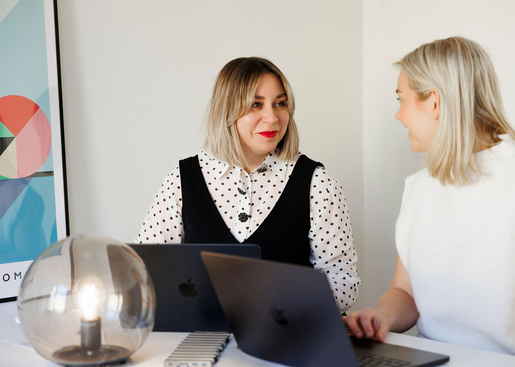 Patricia och Lisa sitter tillsammans med sina laptops